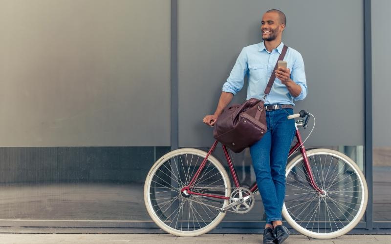 a man on a bicycle posing outdoors