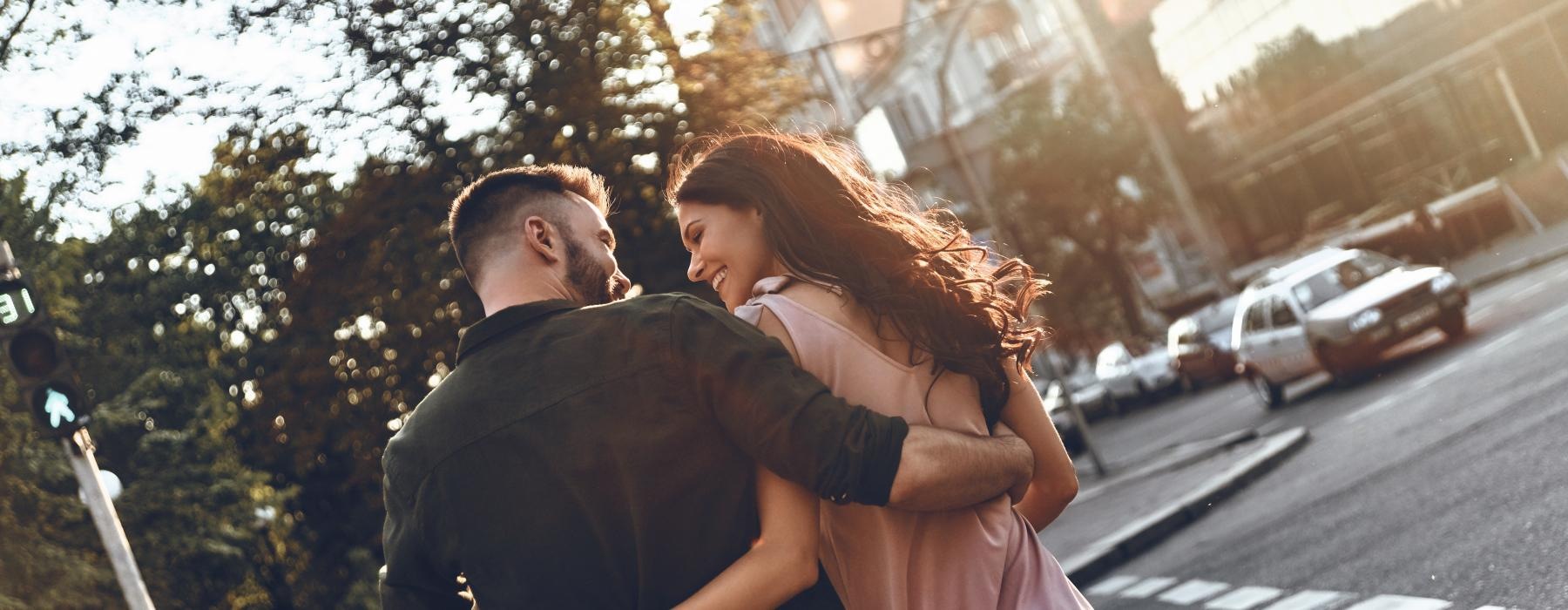 a man and woman walking together outdoors in a city environment